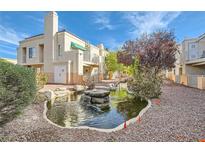 View of beautiful Laguna Del Rey grounds featuring garden landscaping, rock fountain, and building exteriors at 5000 Red Rock St # 105, Las Vegas, NV 89118