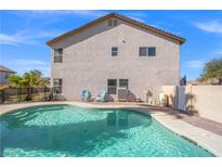 Back of home with an inviting pool and brick-paved pool deck, perfect for outdoor relaxation and entertainment at 5009 Rustic Charm Ct, Las Vegas, NV 89131