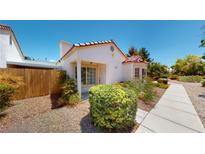 Charming single-story home with a landscaped front yard and a concrete pathway leading to the entrance at 5449 Bugle Way # 102, Las Vegas, NV 89108