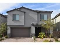 Charming two-story home featuring a low-maintenance front yard, covered entry and an attached two-car garage at 7097 Range Valley St, North Las Vegas, NV 89084