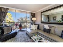 Inviting living room featuring a plush sectional sofa, balcony, and a serene outdoor view at 730 S Royal Crest Cir # 424, Las Vegas, NV 89169