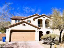 Charming two-story home featuring a tile roof, balcony, and arched entryway at 7342 Caballo Range Ave, Las Vegas, NV 89179