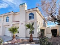 Charming townhome featuring desert landscaping, attached garage, and red tile roofing at 8067 Dorinda Ave, Las Vegas, NV 89147