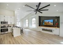 Bright living room boasts a kitchen, modern finishes, and an entertainment center with a fireplace at 9741 Panorama Cliff Dr, Las Vegas, NV 89134