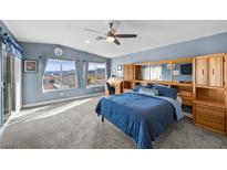 Spacious bedroom features a ceiling fan, carpeted floor, and built in wooden storage at 262 Big Horn Dr, Boulder City, NV 89005