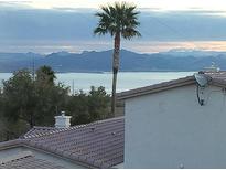 Scenic lake view featuring mountain range and a palm tree in the foreground, captured from the rooftop at 262 Big Horn Dr, Boulder City, NV 89005