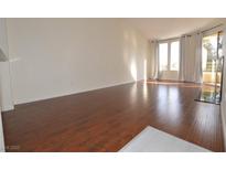 Bright living room with hardwood floors, modern windows, and sliding doors to the balcony at 270 E Flamingo Rd # 327, Las Vegas, NV 89169
