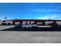 Apartment building exterior showing assigned parking spaces on a sunny day at 3024 Saint George St # G, North Las Vegas, NV 89030