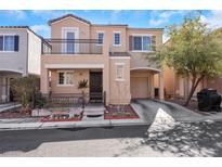 Two-story stucco home with a small front yard, balcony, and attached garage at 6311 Smooth Plain Ave, Las Vegas, NV 89139