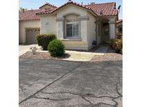 Charming home exterior with a tile roof, manicured landscaping, and a private garage entrance at 1742 Franklin Chase Ter, Henderson, NV 89012