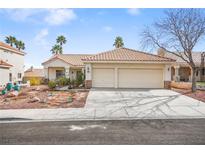 Charming single-story home featuring a well-manicured front yard and a two-car garage at 266 Corvallis Ct, Henderson, NV 89074