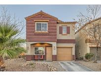 Charming two-story home featuring stucco and textured facade, plus a quaint front yard with desert landscaping at 3411 Holly Ave, Las Vegas, NV 89106