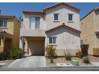 Two story home with an attached garage and a balcony on the second level at 4042 Morning Peace St, Las Vegas, NV 89115