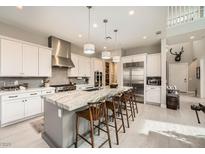 Bright, modern kitchen features a large island with seating and stainless steel appliances at 421 Malpaso St, Las Vegas, NV 89138