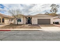 Charming single-story home featuring a tile roof, well-manicured landscape, and an attached two-car garage at 523 Coolidge Ave, Henderson, NV 89015