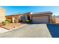 Charming single-story home with a two-car garage and well-maintained landscaping at 5282 Panguitch Dr, Las Vegas, NV 89122
