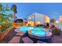 Inviting backyard with a sparkling pool, hot tub, landscape and covered patio, perfect for outdoor entertaining at 6005 Crystal Talon St, Las Vegas, NV 89130