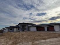 Contemporary home exterior featuring a spacious three car garage and modern design elements at 6383 Horse Dr, Las Vegas, NV 89131