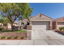 Charming single-story home featuring a two-car garage, mature landscaping, and gated front entry at 6816 Royal Poinciana Ct, Las Vegas, NV 89131