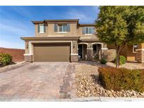 Two-story home with a two car garage and desert landscaping at 7884 Patagonia Point Ct, Las Vegas, NV 89179