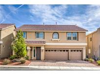 Charming two-story home featuring a three-car garage and well-manicured landscaping, inviting curb appeal at 9876 Parador Cellars Ct, Las Vegas, NV 89141