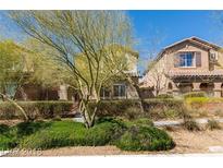 Inviting two-story home featuring desert landscaping, private fences, and convenient sidewalk access at 10085 S Riley St, Las Vegas, NV 89178