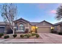 Charming single-story home featuring a well-manicured front yard and an attached two-car garage at 10217 Queens Church Ave, Las Vegas, NV 89135