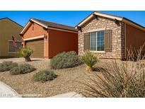 Charming single-story home with desert landscaping and a stone facade accent at 1455 Waterfall Ln, Mesquite, NV 89034