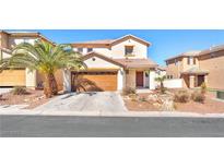 Charming two-story home featuring desert landscaping and a well-maintained lawn at 2526 Begonia Valley Ave, Henderson, NV 89074