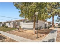 Charming single-story home with desert landscaping and mature trees in a quiet neighborhood at 275 N Lamb Blvd # E, Las Vegas, NV 89110