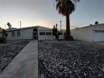 Charming single-story home with desert landscaping and mature palm tree at 3647 Ottawa Cir, Las Vegas, NV 89169