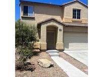 Two-story home showcasing a well-kept lawn and inviting entryway at 4039 Meadow Foxtail Dr, Las Vegas, NV 89122