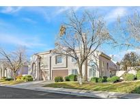 Two-story home boasting mature trees, a well-manicured lawn, and attached two-car garage at 510 Crumpler Pl, Henderson, NV 89052