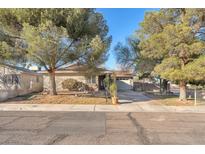 Charming single-story home with mature trees, a well-maintained yard, and an inviting facade at 5640 Vasila Dr, Las Vegas, NV 89110