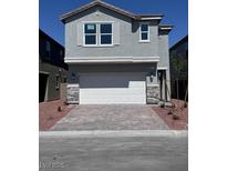 Beautiful two-story home featuring stone accents, a spacious two-car garage, and manicured landscaping at 6616 Bowery St, Las Vegas, NV 89148