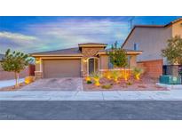 Charming single-story home featuring stone accents, a two-car garage, and desert landscaping at 7106 Stanley Frederick St, Las Vegas, NV 89166