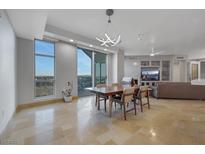 Bright and airy living room with modern light fixture and city view at 9103 Alta Dr # 404, Las Vegas, NV 89145