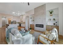 Bright living room featuring a cozy seating area and a modern fireplace with built-in shelving at 1 Club Vista Dr, Henderson, NV 89052