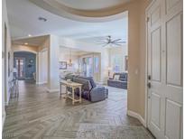 Inviting foyer with tile flooring and an open floor plan flows into the spacious living and dining areas at 10446 Abbotsbury Dr, Las Vegas, NV 89135