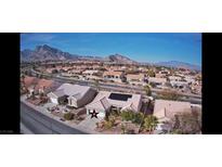 Expansive community shot featuring desert landscaping and mountain views under a clear blue sky at 10528 Cogswell Ave, Las Vegas, NV 89134