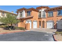 Inviting multi-level townhome featuring a private 2-car garage and beautiful terracotta-toned stucco at 16 Via Visione # 101, Henderson, NV 89011