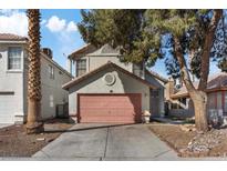 Charming two-story home featuring a pink garage door, mature trees, and a well-maintained front yard at 1939 Dry Falls St, Las Vegas, NV 89142