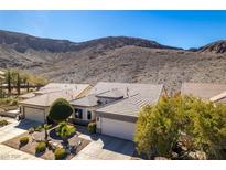 Inviting single-story home featuring desert landscaping, a two-car garage, and a tile roof at 2035 King Mesa Dr, Henderson, NV 89012