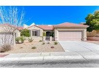 Charming single-story home featuring desert landscaping, a tile roof, and an attached two-car garage at 2702 Grand Forks Rd, Henderson, NV 89052