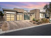 Stunning single-story home featuring a stylish stone facade and three-car garage at 32 Hunting Horn Dr, Las Vegas, NV 89135