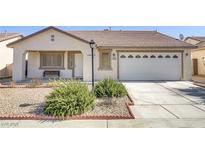 Charming single-story home boasts a well-manicured front yard and inviting curb appeal at 3508 Blown Glass Dr, North Las Vegas, NV 89032