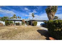 Charming single-story home with a two-car garage, desert landscaping, and mature palm trees at 3910 Woodhill Ave, Las Vegas, NV 89121