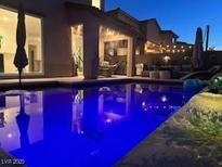 Inviting pool with lounge area, perfect for relaxing evenings and outdoor entertaining at 4138 Bayley Skye Ave, Las Vegas, NV 89141