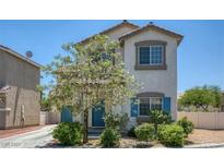 Charming two-story home featuring a well-maintained yard and appealing architectural details at 5635 Low Stakes Ct, Las Vegas, NV 89122