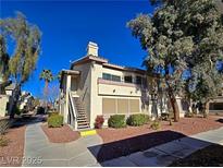 Charming two-story condo featuring well-maintained landscaping and a private entrance on a clear, sunny day at 5710 E Tropicana Ave # 1018, Las Vegas, NV 89122